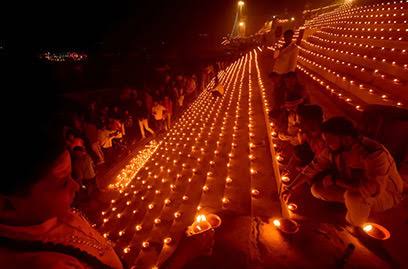 Diya lights lining a ghat at night